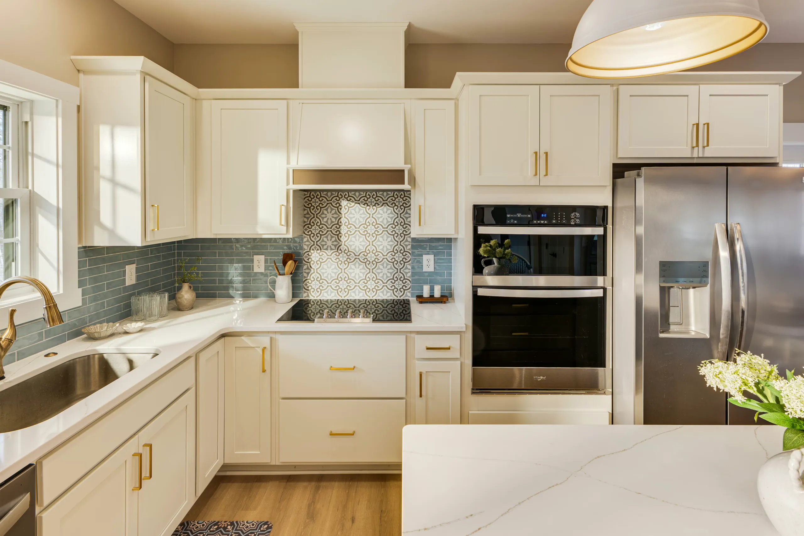 White shaker kitchen with double wall oven and patterned backsplash tile in the Reservoir Home