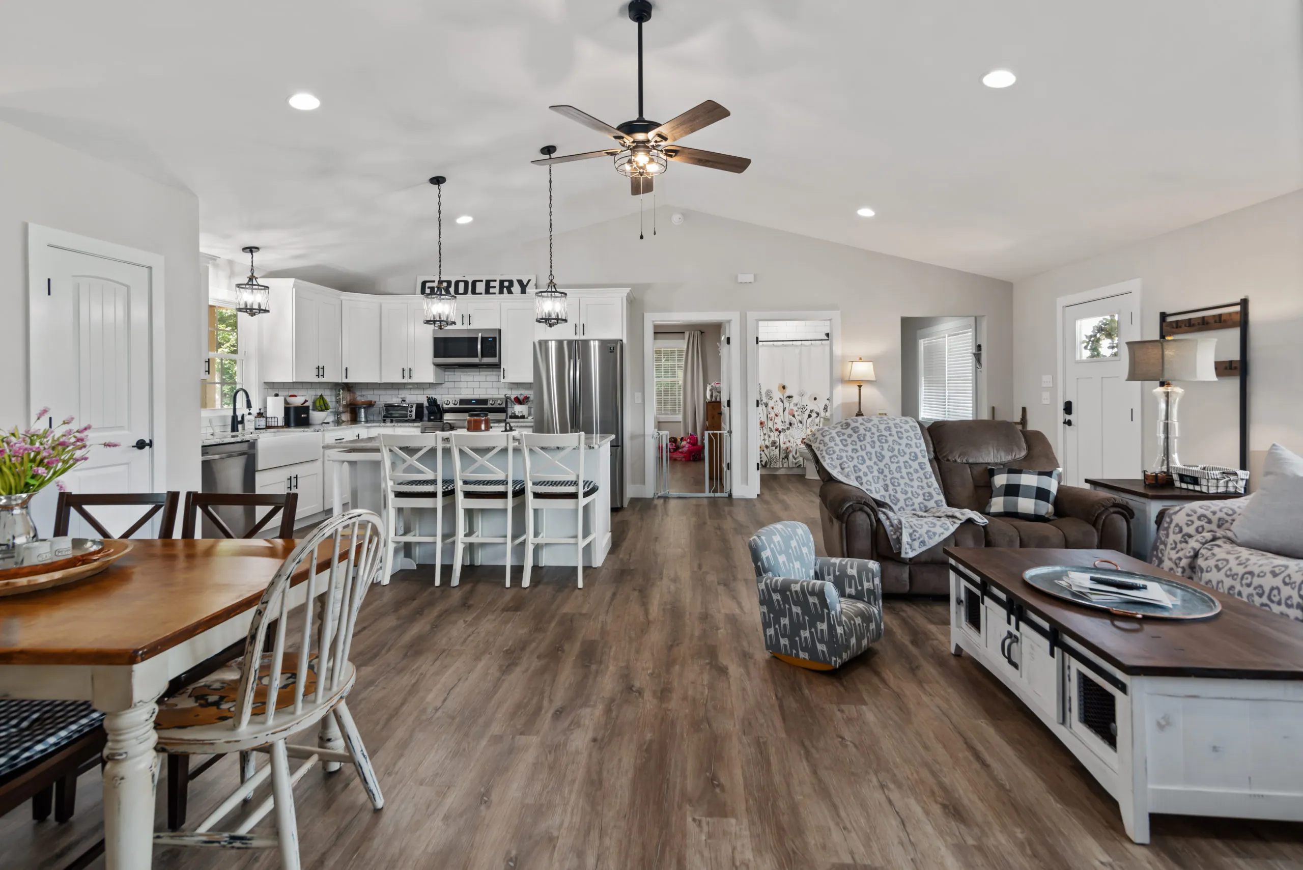 Open kitchen, dining and living area with vaulted ceiling in the Lake Cross Home