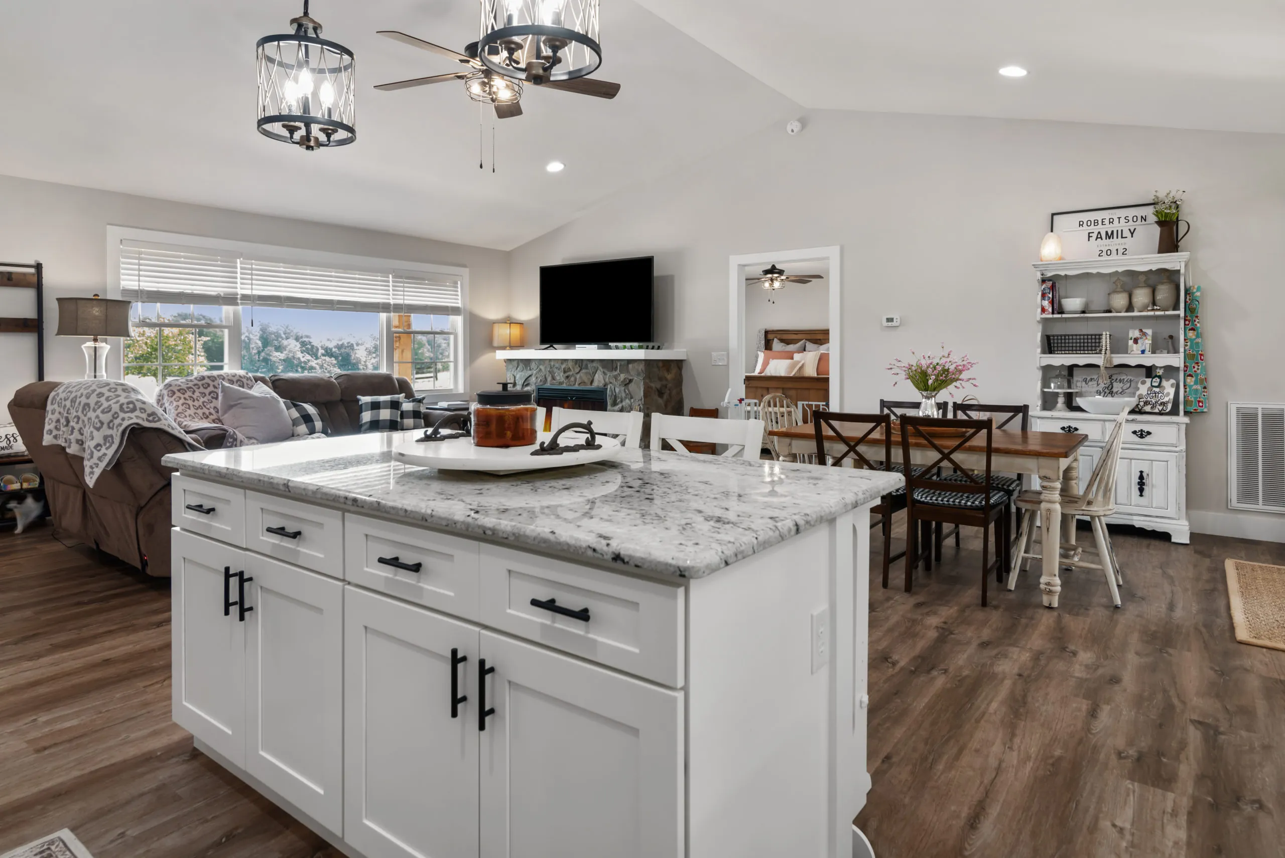 Kitchen island with granite top looking toward the dining area and fireplace in the Lake Cross Home