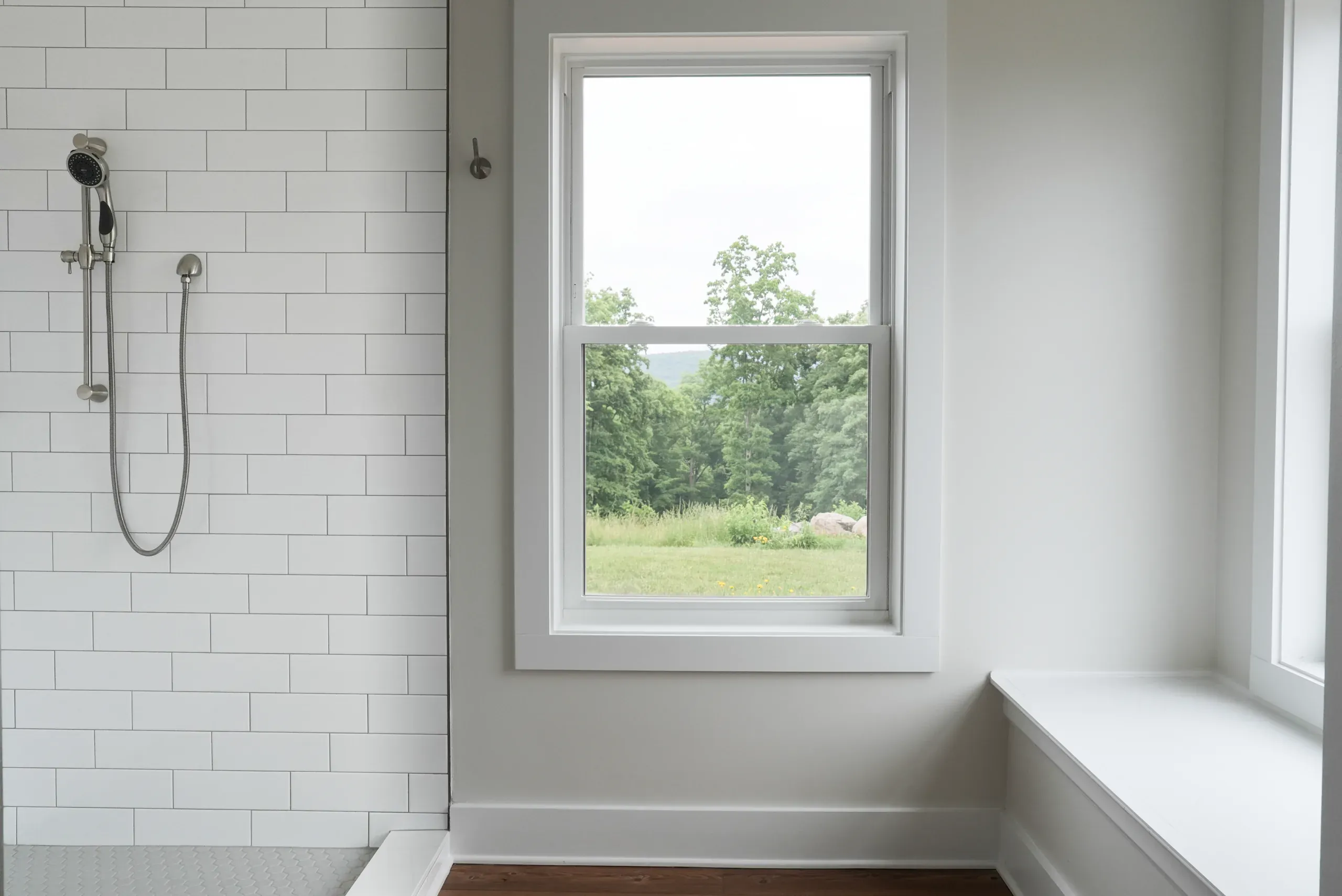 Primary bathroom shower and window with a view of the field in the Mountain Crest Home
